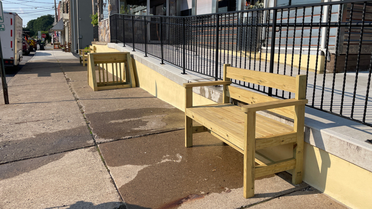 A newly constructed wood bench and bicycle rack on display in White Haven