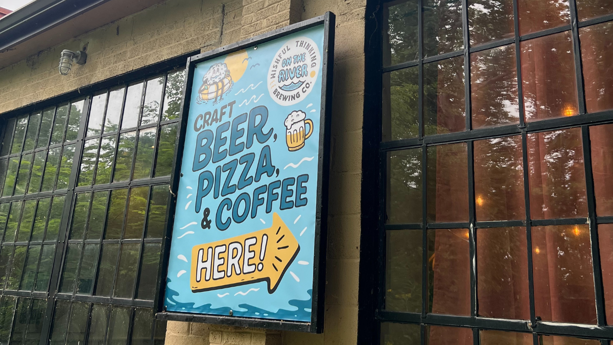 Craft beer, pizza, & coffee sign on the outside of a wall