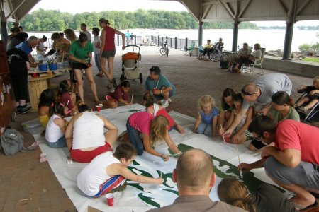 Community members gather to create the mural.