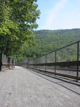 The D&L Trail crosses the Nesquehoning Trestle, with an active rail line on the right